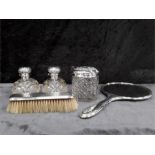 A quantity of silver topped scent bottles together with a part silver dressing table set.