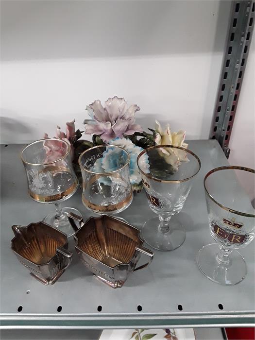 Silver sugar and cream bowls together with four glasses and a piece of flower china.