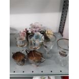 Silver sugar and cream bowls together with four glasses and a piece of flower china.