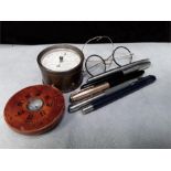 Pens, pair of antique rimed glasses a barometer in brass case and compass in a turned wood case