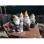 Four large garden gnomes.