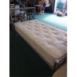A single bedstead with a Dreams Mirage mattress.