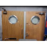 A pair of port holed fire doors with closers.
