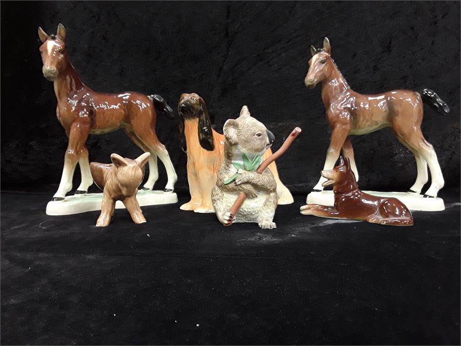 A small quantity of glazed china animals to include German horses, Afghan Hound etc.