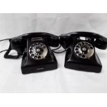 Two black Bakelite telephones.