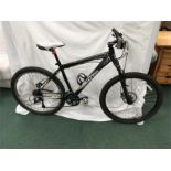 A Scott mountain bike. 24 speed with front suspension, hydraulic disc brakes and rear light. Some