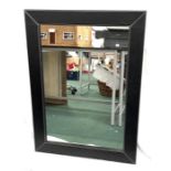 A large leather framed mirror