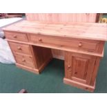 A large pine twin pillar desk.