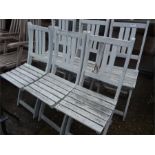 A set of six folding garden chairs.