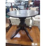 A circular quad foot occasional table.