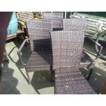 A plastic rattan set of four garden chairs.
