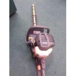 A Ryobi petrol hedge trimmer.