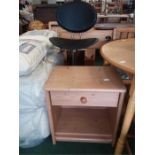 A pine bedside cabinet together with a kitchen stool.