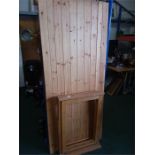 A pine slatted door together with a window frame.