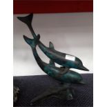 A metal ornament depicting dolphins.