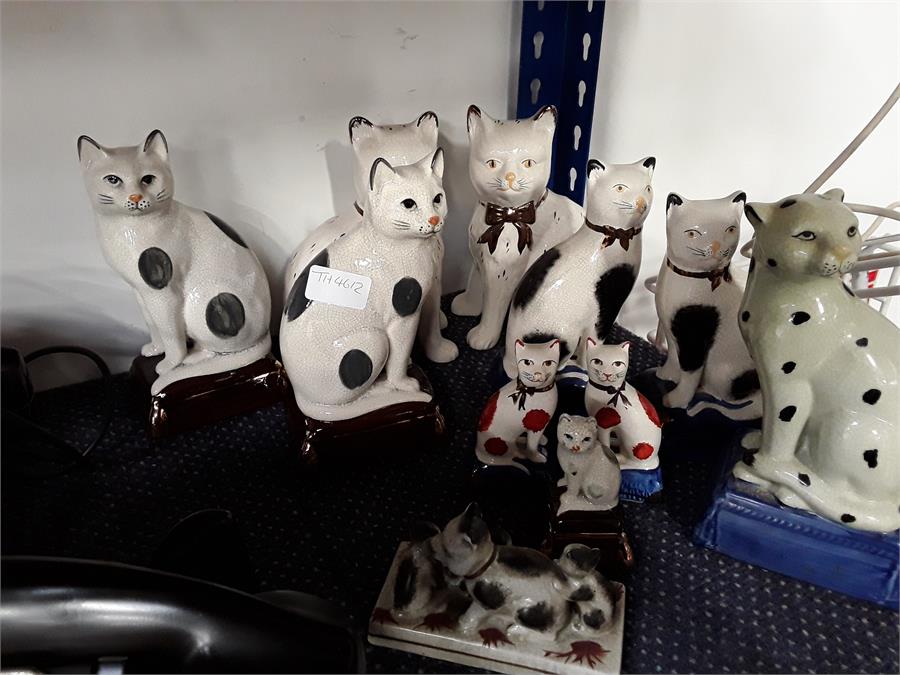 Various pairs of china cats.