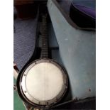 A vintage cased banjo.