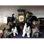 Various elephant ornaments together with a planter.