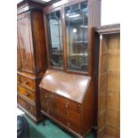 A three drawer mahogany bureau bookcase.