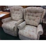 A his and hers reclining manual wingback armchairs.