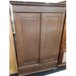 A German design mahogany stained pine double wardrobe with drawer to base.