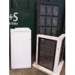 A glazed door and window together with cupboard doors.