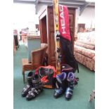 A pair of Salomon ski's together with two pairs of ski boots.