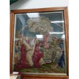 A framed religious tapestry.