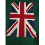 A large vintage union Jack flag with a box containing pin badges etc.