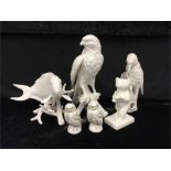 Six Goebel ceramic models including woodpecker, owls, fish, bear and bird of prey.