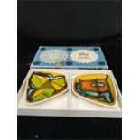 Two boxed Poole Pottery Delphis shaped dishes.