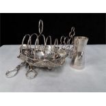 A silver toast rack with other plate grape , tot etc