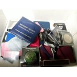 A box containing commemorative coins etc