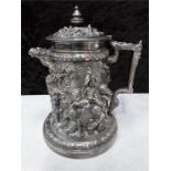 A Victorian silver plate beer jug with embossed and raised decoration.