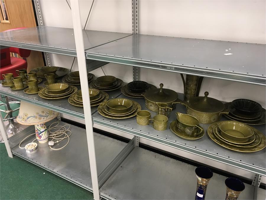 A large green Portmerion pottery dinner service in the “Totem” pattern.