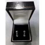 a pair of mounted drop diamond Earrings. in case