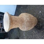 A wicker clad ceramic urn.