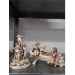 Two German china figurines of Putti and children (af).