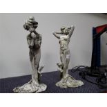 Two female garden ornaments, made of metal.