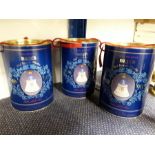 Three Bell's Scotch Whisky decanters in cardboard canisters depicting the Queen Mother's 90th