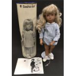 Sasha Trendon Blonde 4-107: girl doll with blonde hair, blue painted eyes, dark grey cord to legs