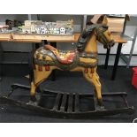 A large decorative wooden horse on rocker base. Height 112cm, length 155cm approx.