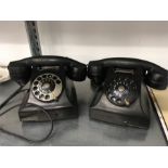 Two black vintage Bakelite telephones.