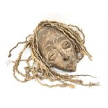 An African carved tribal mask with hemp hair.