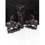 Three Chinese hardwood and inlaid figures of men on bullocks and a goddess.