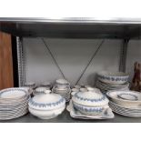 A quantity of Wedgewood Queens ware dinner service in white and embossed blue slip (51 pieces).