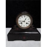 A Victorian black slate and marble mantle clock.