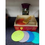 A Fisher-Price music box record player together with a tub of marbles.