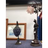 A table lamp depicting a lady (af) together with another.