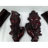 Two Oriental wall hanging figures together with four wooden stands.